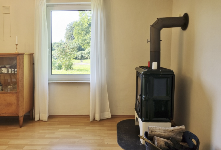 Kaminofen im Esszimmer. Im Vordergrund Esstisch.